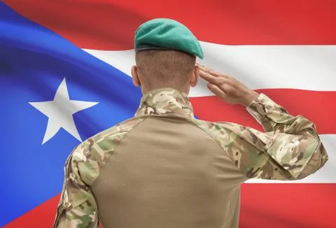 Dark-skinned soldier in hat facing national flag series - Puerto Rico Stockfoto's