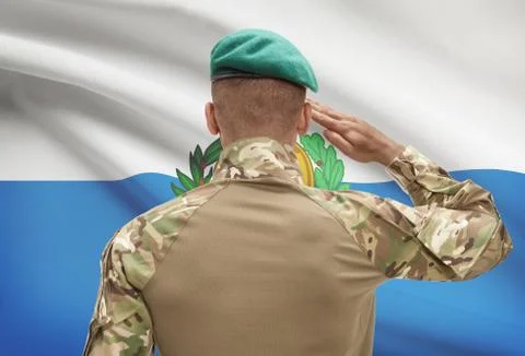 Dark-skinned soldier in hat facing national flag series - San Marino 写真素材