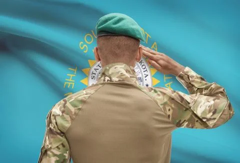 Dark-skinned soldier in hat facing US state flag series - South Dakota 写真素材