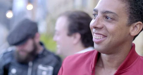 Dark skinned young man smiling and drinking beer at city loft party 4K Stock Footage 63497576
