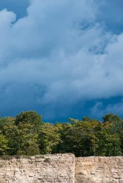 Dark sky and clouds  with trees with limestone cliff landscape Stock Photos