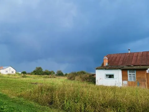 Dark sky with clouds and a thunderstorm on the horizon. Against the background Stock Photos