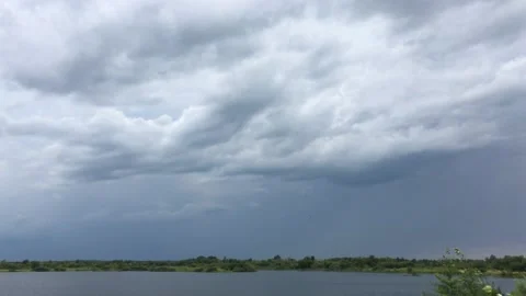 Dark sky with clouds over the lake. A storm is coming Stock Footage 135626803