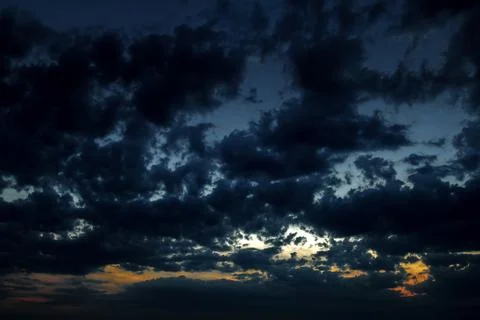 Dark sky with clouds at sunset Stock Photos