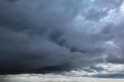 The dark sky had clouds gathered to the left and a strong storm before it rai Stock Photos
