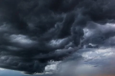 The dark sky had clouds gathered to the left and a strong storm before it r.. Stock Photos