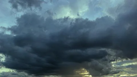 The dark sky had clouds gathered to the left and a strong storm before it r.. Stock Photos