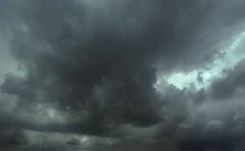 The dark sky had clouds gathered to the left and a strong storm before it r.. Stock Photos