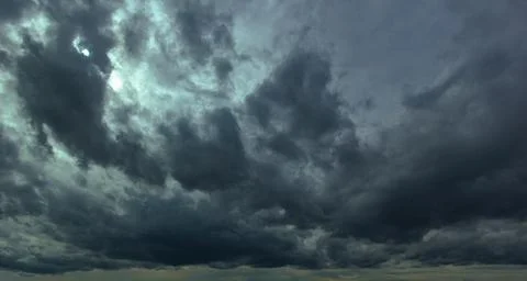 The dark sky had clouds gathered to the left and a strong storm before it r.. Stock Photos