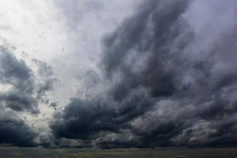 The dark sky had clouds gathered to the left and a strong storm before it r.. Stock Photos