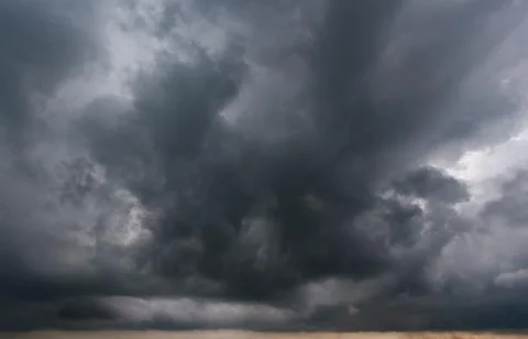 The dark sky had clouds gathered to the left and a strong storm before it r.. Stock Photos