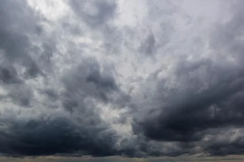 The dark sky had clouds gathered to the left and a strong storm before it r.. Stock Photos