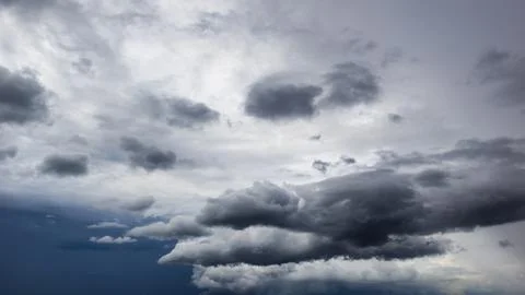 The dark sky had clouds gathered to the left and a strong storm before it r.. Stock Photos