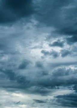 The dark sky with heavy clouds converging and a violent storm before the rain. Stock Photos