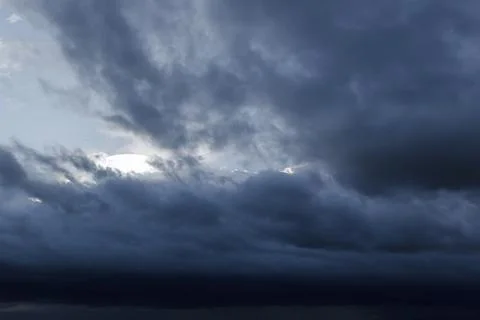 The dark sky with heavy clouds converging and a violent storm before the rain Stock Photos