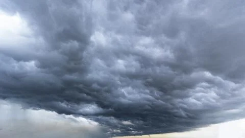 The dark sky with heavy clouds converging and a violent storm before the rain Stock Photos
