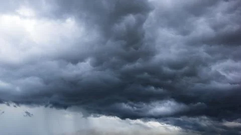The dark sky with heavy clouds converging and a violent storm before the rain Stock Photos