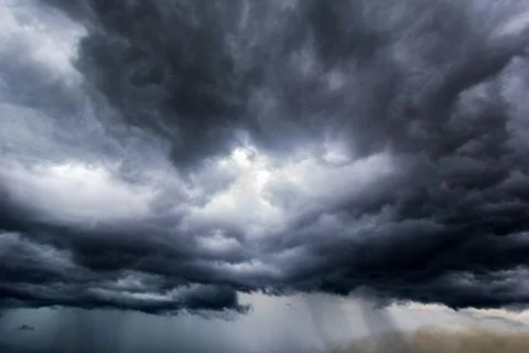 The dark sky with heavy clouds converging and a violent storm before the rain Stock Photos