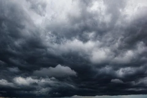 The dark sky with heavy clouds converging and a violent storm before the ra.. Stock Photos