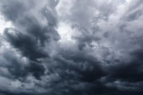 The dark sky with heavy clouds converging and a violent storm before the ra.. Stock Photos
