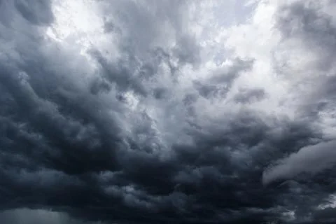 The dark sky with heavy clouds converging and a violent storm before the ra.. Stock Photos