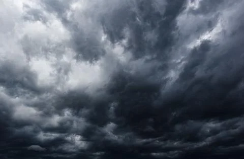 The dark sky with heavy clouds converging and a violent storm before the ra.. Stock Photos
