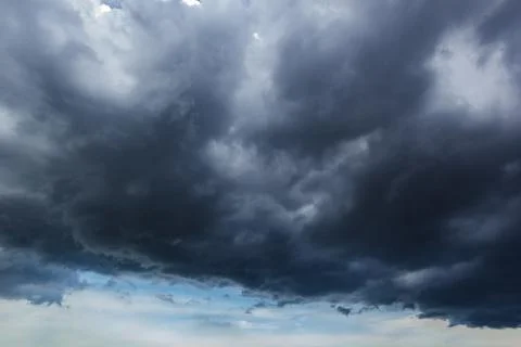 The dark sky with heavy clouds converging and a violent storm before the ra.. Stock Photos
