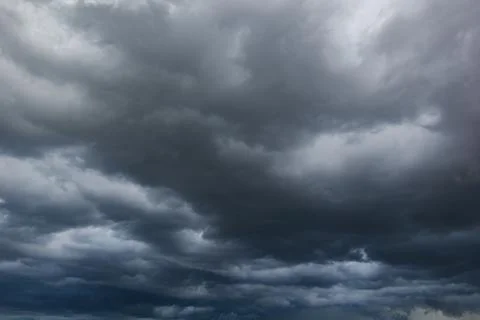 The dark sky with heavy clouds converging and a violent storm before the ra.. Stock Photos