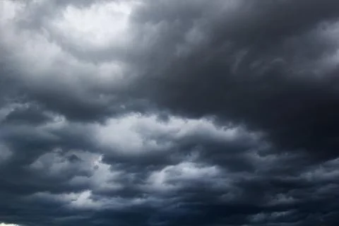 The dark sky with heavy clouds converging and a violent storm before the ra.. Stock Photos