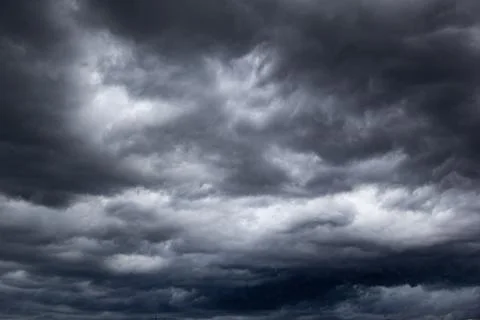 The dark sky with heavy clouds converging and a violent storm before the ra.. Stock Photos