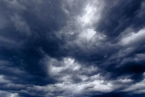 The dark sky with heavy clouds converging and a violent storm before the ra.. Stock Photos