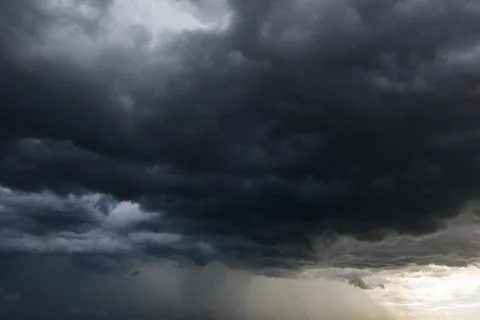 The dark sky with heavy clouds converging and a violent storm before the ra.. Stock Photos