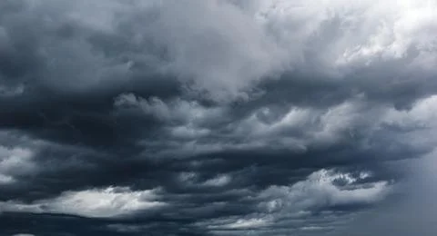 The dark sky with heavy clouds converging and a violent storm before the ra.. Stock Photos