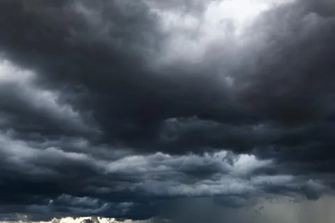 The dark sky with heavy clouds converging and a violent storm before the ra.. Stock Photos