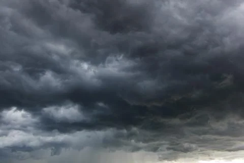 The dark sky with heavy clouds converging and a violent storm before the ra.. Stock Photos