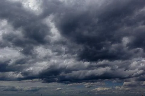 The dark sky with heavy clouds converging and a violent storm before the ra.. Stock Photos