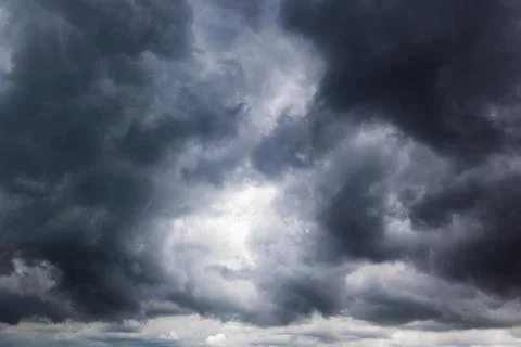 The dark sky with heavy clouds converging and a violent storm before the ra.. Stock Photos