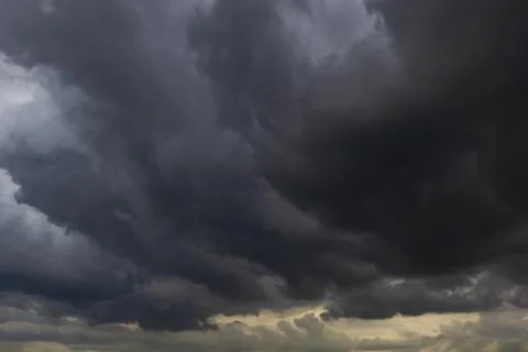 The dark sky with heavy clouds converging and a violent storm before the ra.. Stock Photos