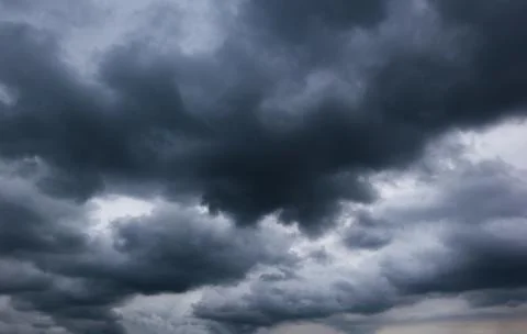 The dark sky with heavy clouds converging and a violent storm before the ra.. Stock Photos