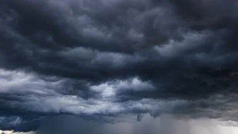 The dark sky with heavy clouds converging and a violent storm before the ra.. Stock Photos