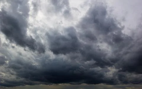 The dark sky with heavy clouds converging and a violent storm before the ra.. Stock Photos