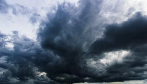 The dark sky with heavy clouds converging and a violent storm before the ra.. Stock Photos