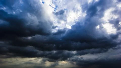 The dark sky with heavy clouds converging and a violent storm before the ra.. Stock Photos