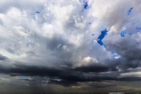The dark sky with heavy clouds converging and a violent storm before the ra.. Stock Photos