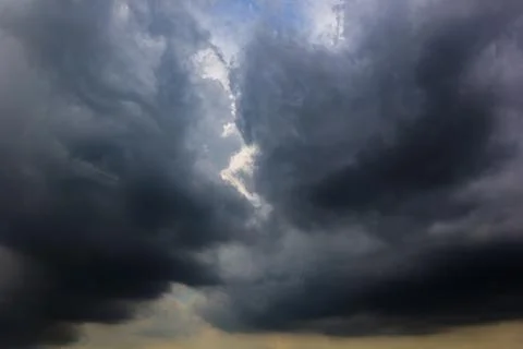 The dark sky with heavy clouds converging and a violent storm before the ra.. Stock Photos