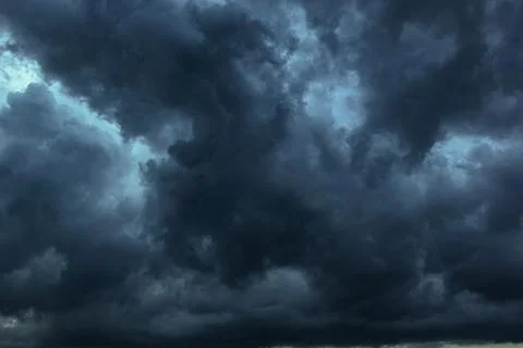 The dark sky with heavy clouds converging and a violent storm before the ra.. Stock Photos