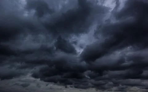 The dark sky with heavy clouds converging and a violent storm before the ra.. Stock Photos