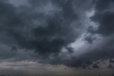 The dark sky with heavy clouds converging and a violent storm before the ra.. Stock Photos