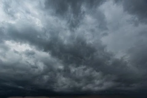 The dark sky with heavy clouds converging and a violent storm before the ra.. Stock Photos