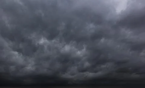 The dark sky with heavy clouds converging and a violent storm before the ra.. Stock Photos